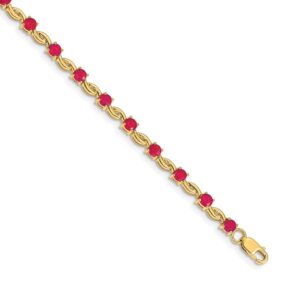 Elegant gold bracelet with red gemstones.